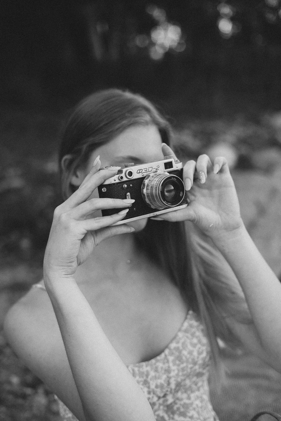 Sophie with a rangefinder camera, washed film tones