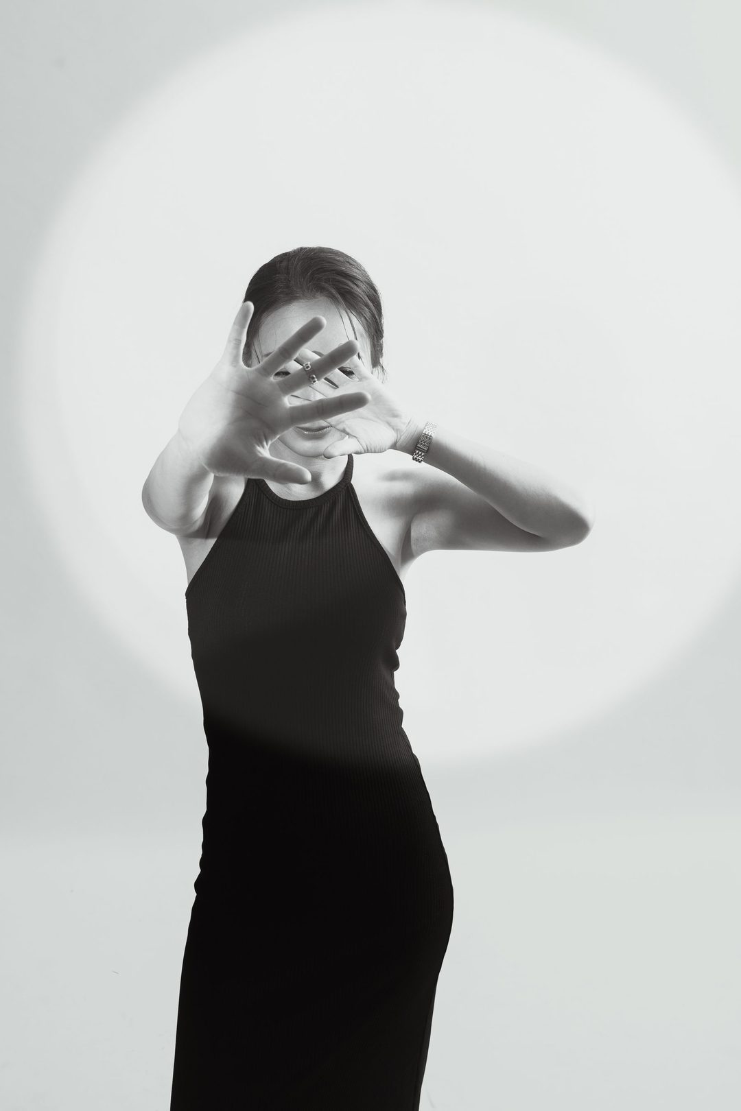 Black tank, hand raised