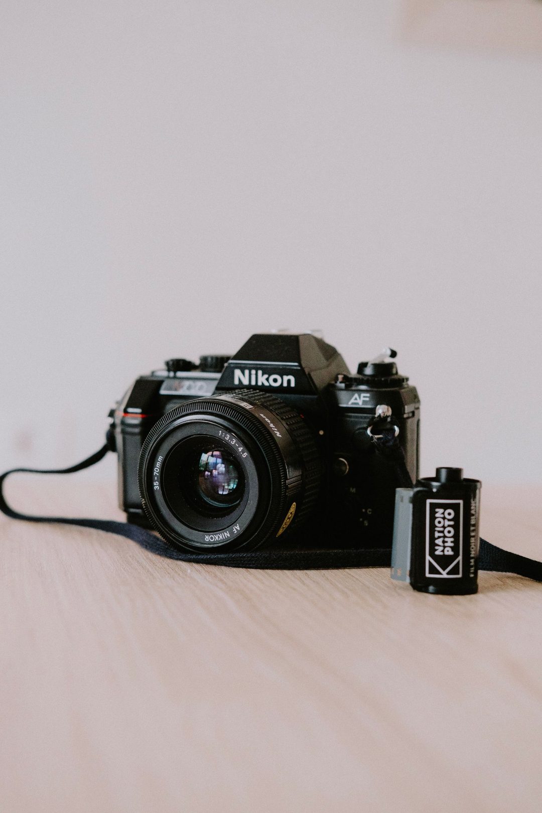 Black 35mm SLR with a roll of film
