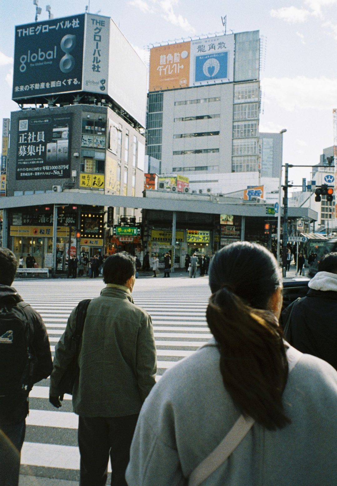 Pedestrians waiting at a city crossing