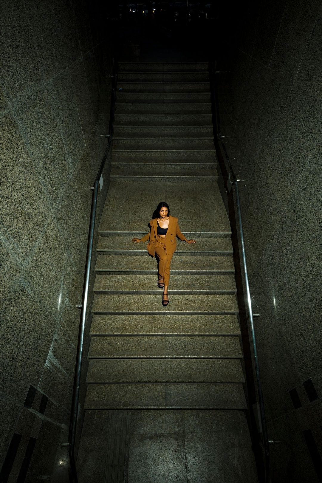 Figure descending a stairwell, seen from above