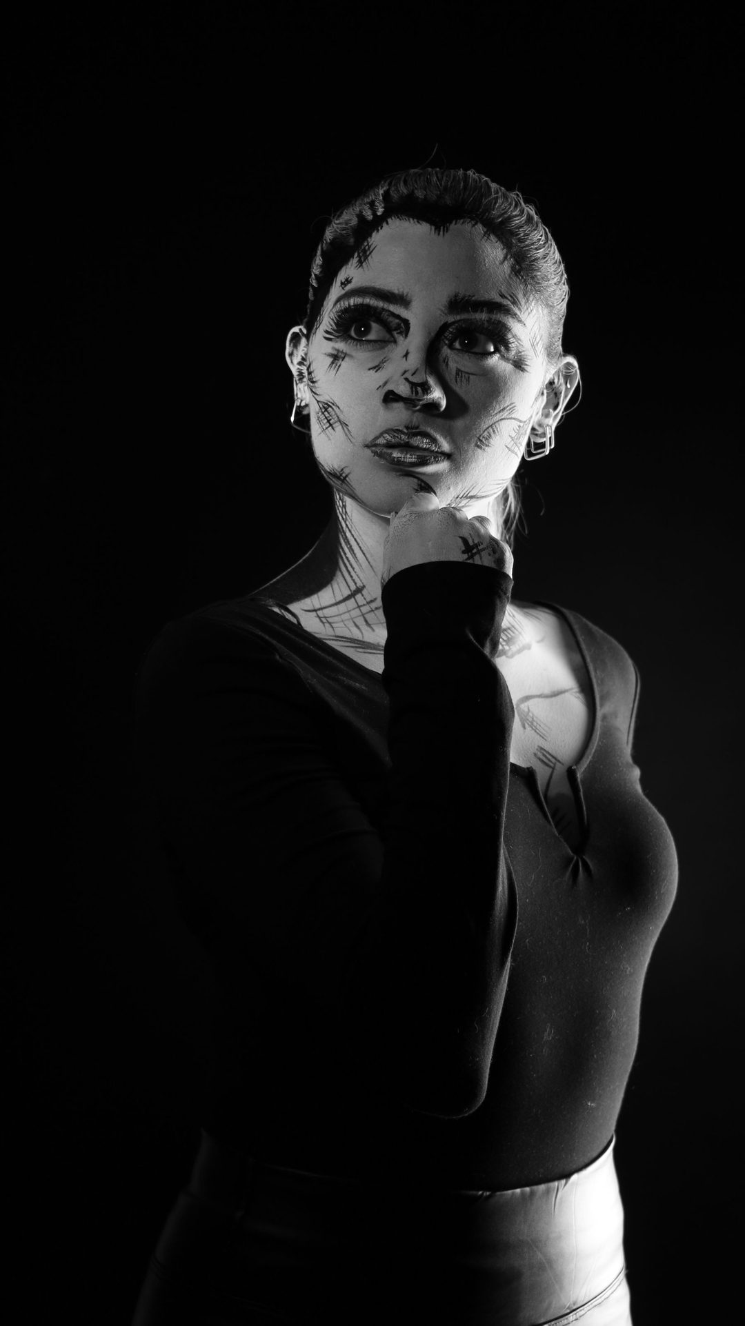 Portrait with raised arm against seamless backdrop