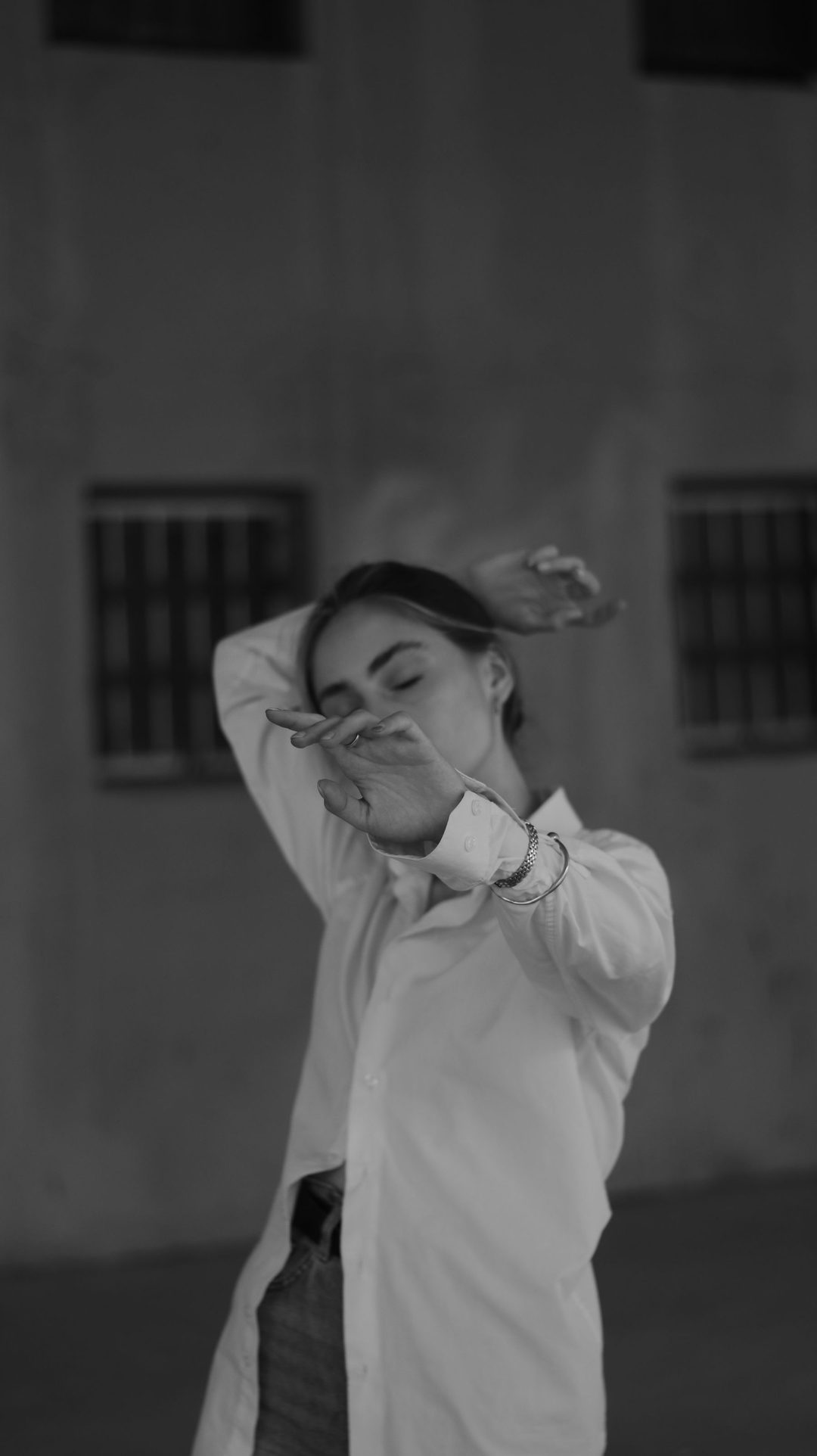 Dancer in white shirt, face in hand