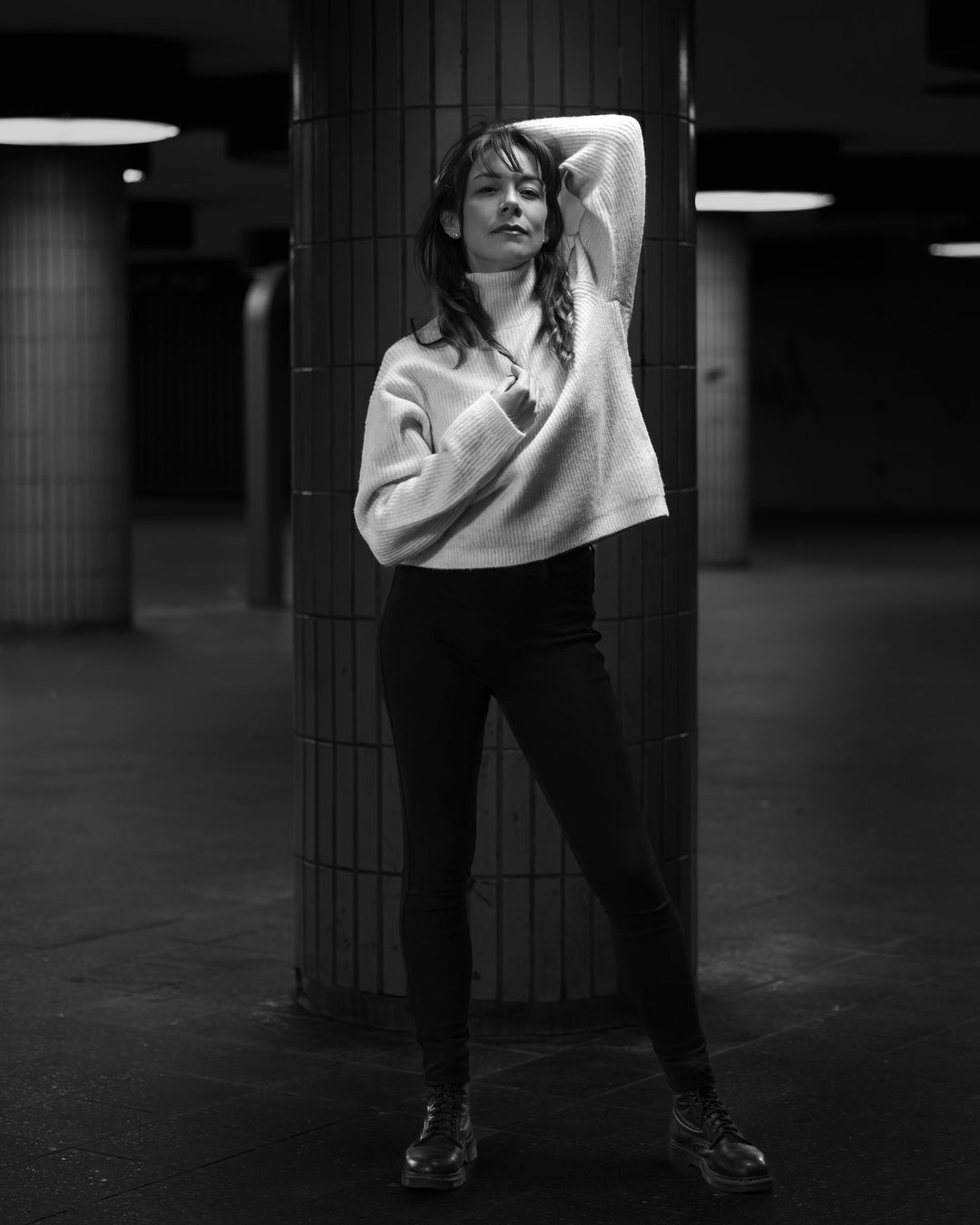 Figure leaning at a stone column