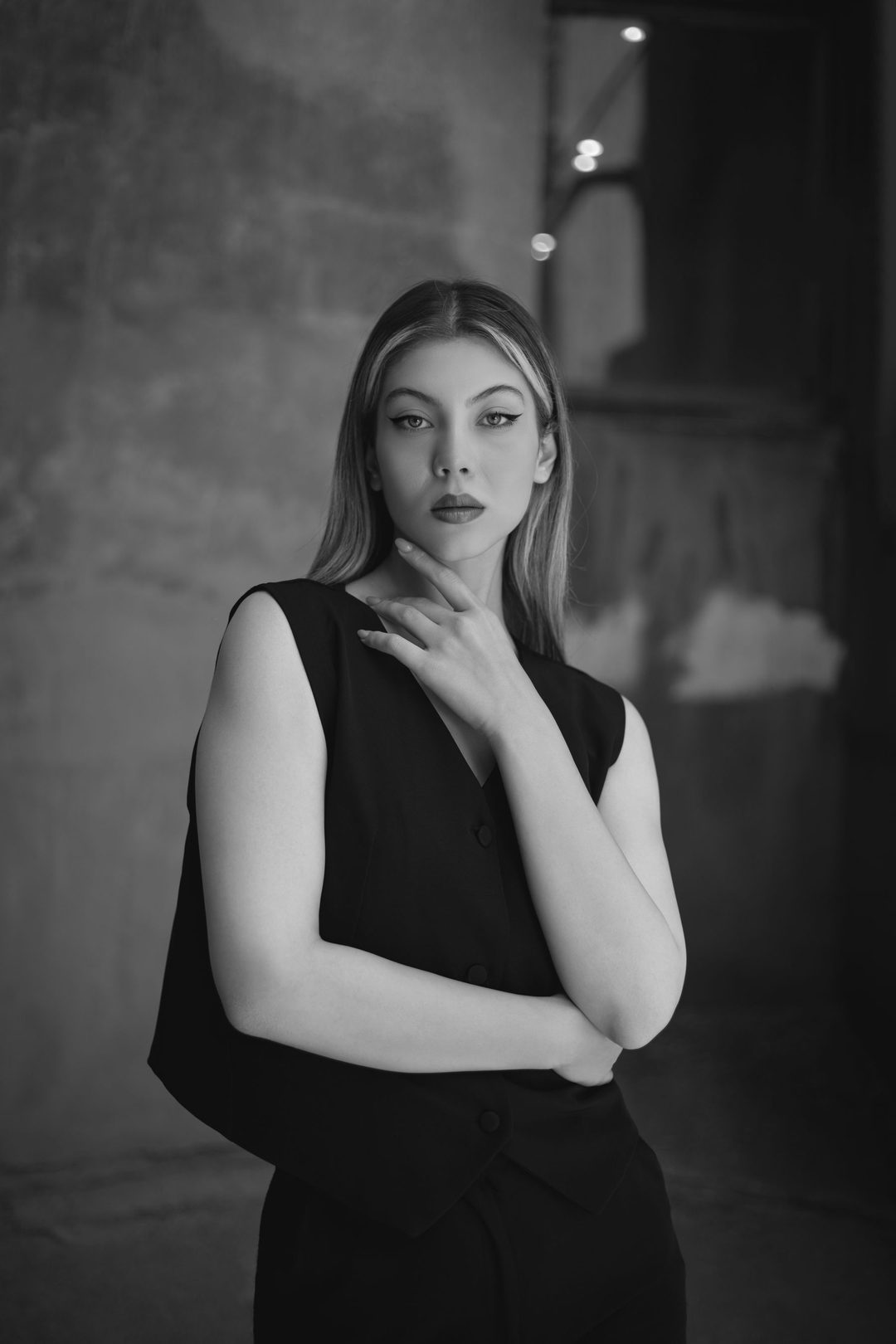 Portrait in black dress, hand at chin